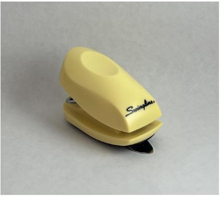 Plastic stapler photographed inside a DIY lightbox